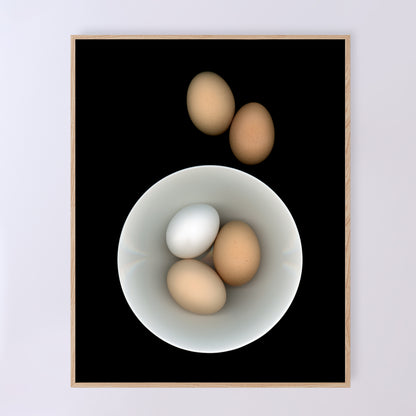 Breakfast anyone? Three eggs in a white bowl with two brown egg on the side on a black background. Open edition 11x14 inches print in a dining setting by Carmen Grenier. OE-353-2