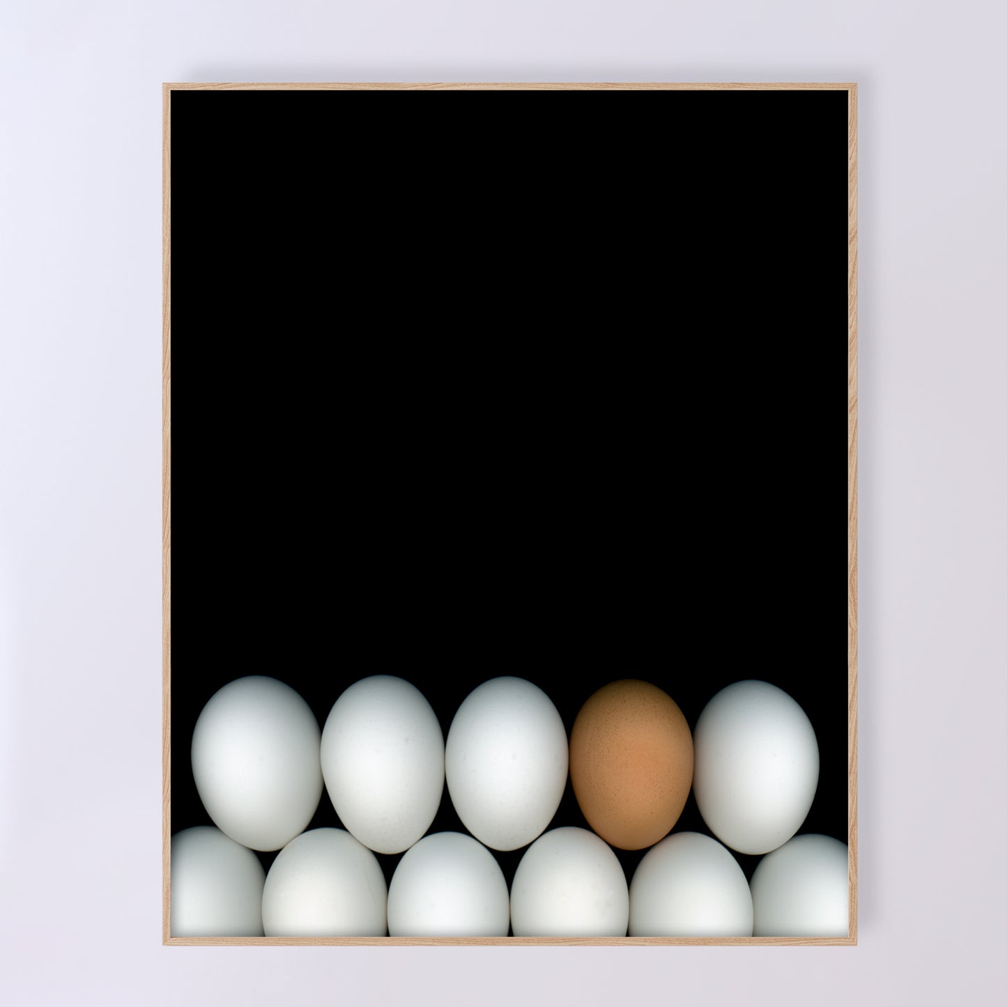 Two rows of white chicken eggs with one brown egg  on a black background. Open edition 18x20 inches print by Carmen Grenier. OE-354-3