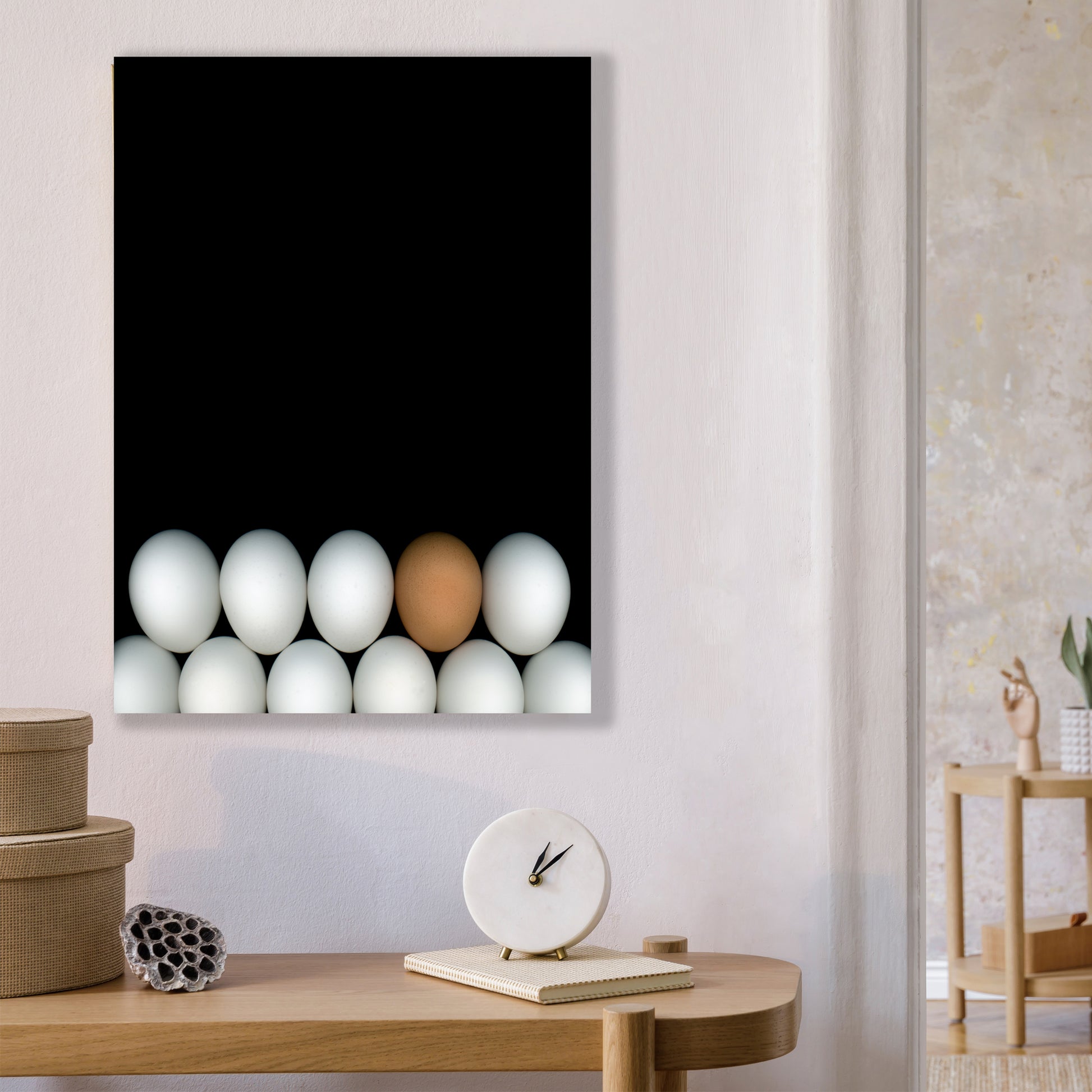 Two rows of white chicken eggs with one brown egg  on a black background open edition print in home setting. Open edition 8x10 inches print by Carmen Grenier. OE-354.