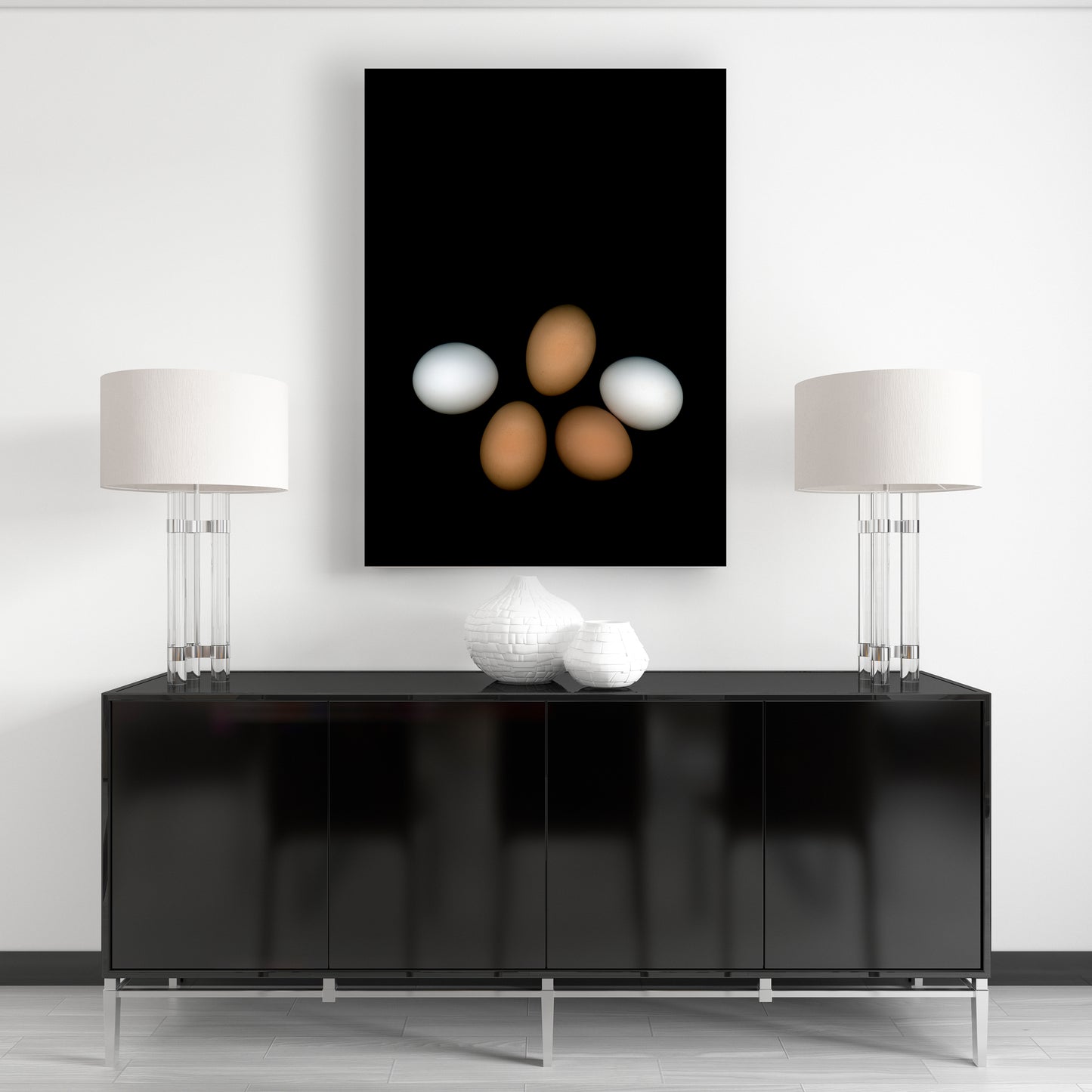 PLayfull display of 5 chicken eggs, three brown and two white on a black background.  OE-356 Open edition print in a home environment  by Carmen Grenier.